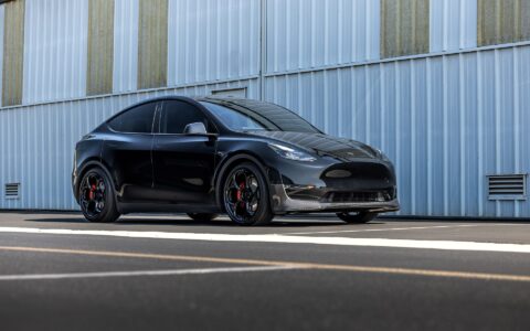 Tesla Model Y outfitted with Unplugged Performance carbon fiber front lip spoiler and UP-05 wheels, emphasizing the custom aesthetic and performance upgrade.