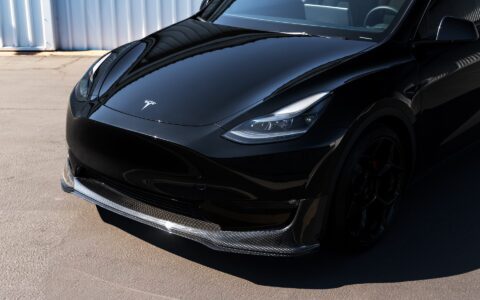 Side angle of a Tesla Model Y featuring Unplugged Performance's UP-05 wheels and carbon fiber front lip spoiler, highlighting the vehicle's enhanced stance and upgraded aerodynamics.