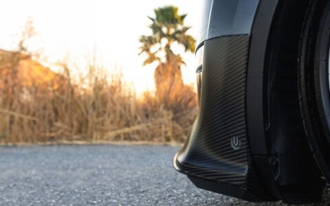 Side profile front shot of carbon fiber lip spoiler and diffuser.